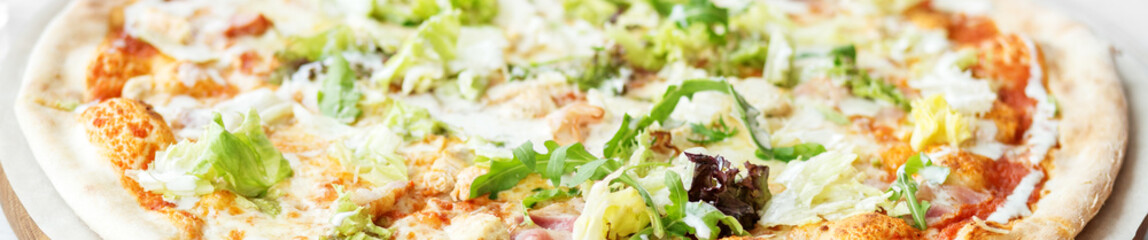 Delicious big pizza with cheese and ham. Close-up. The concept of food, fast food, Italian pizza.