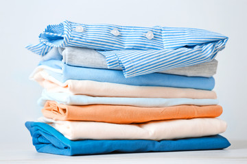 Stack of colorful cotton clothes. Heap of   folded laundry.