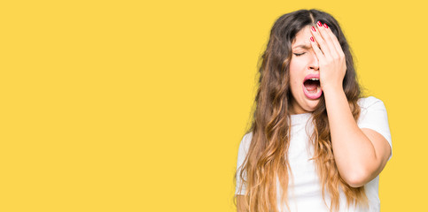 Young beautiful woman wearing casual white t-shirt Yawning tired covering half face, eye and mouth with hand. Face hurts in pain.