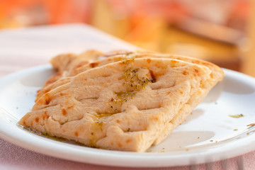 Authentic Mediterranean pitta bread served in a romantic Greek restaurant, on the island of Santorini, Greece.