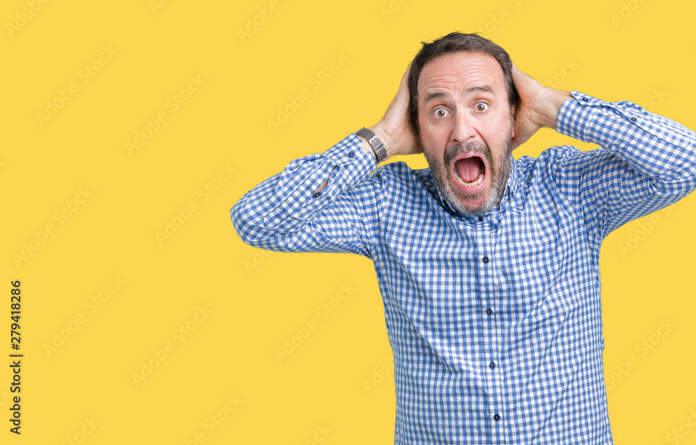 Poster Handsome middle age elegant senior man over isolated background Crazy and scared with hands on head, afraid and surprised of shock with open mouth