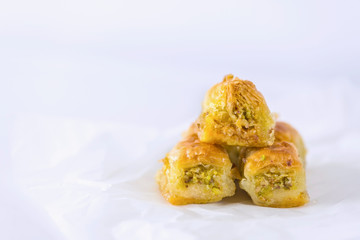 Turkish traditional dessert Baklava on a backing paper, close up