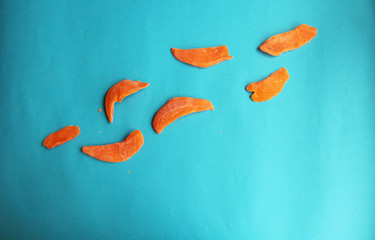 dried fruits mango orange slice on blue bright background. Tasty yummy dieting