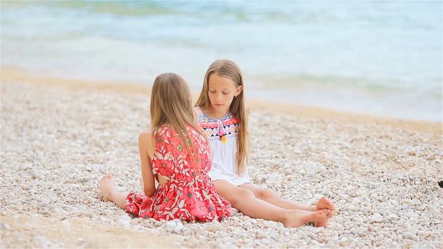 Little girls having fun at tropical beach during summer vacation