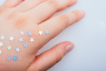 Little stars on a on hand on gray background