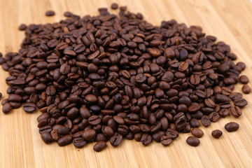 Fototapeta na wymiar Coffee beans on wood