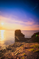 Obraz premium View of a beach at Bell Island, Newfoundland, Canada during sunset