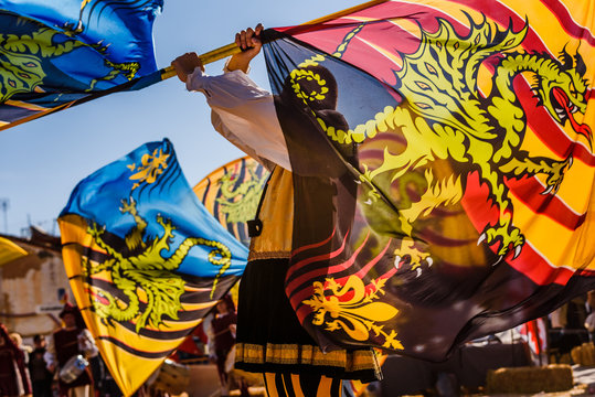 Valencia, Spain- January 27, 2019: Italian Flags-wavers, Sbandieratori, performing the traditional and antique dance by throwing flags in the air, during a medieval festival.