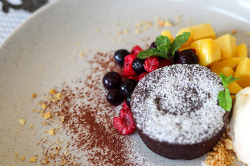 Delicious and beautiful dessert of .Chocolate cake with summer berries,mango.