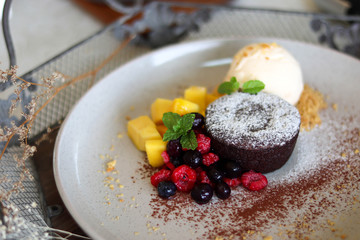 Delicious and beautiful dessert of .Chocolate cake with summer berries,mango.