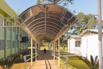 School and boy walking on walkway