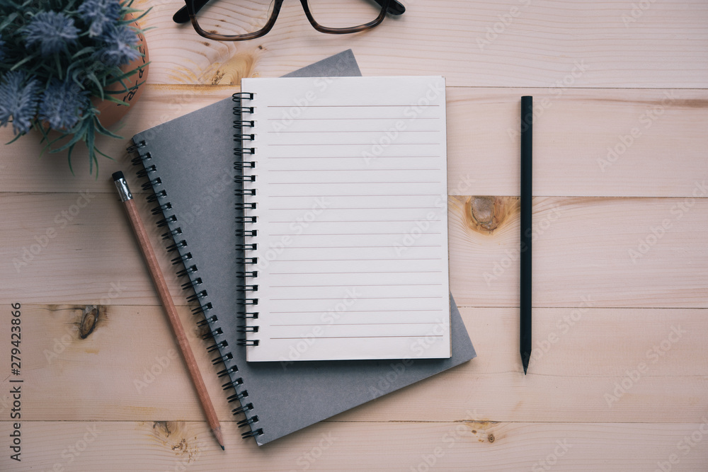 Poster notebook blank notebook with pencil on wooden background.
