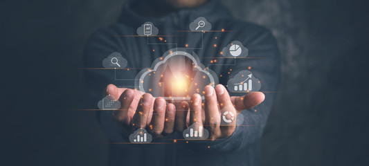 Big data analytics and business intelligence concept with chart and graph icons on a digital screen interface and a businessman in background