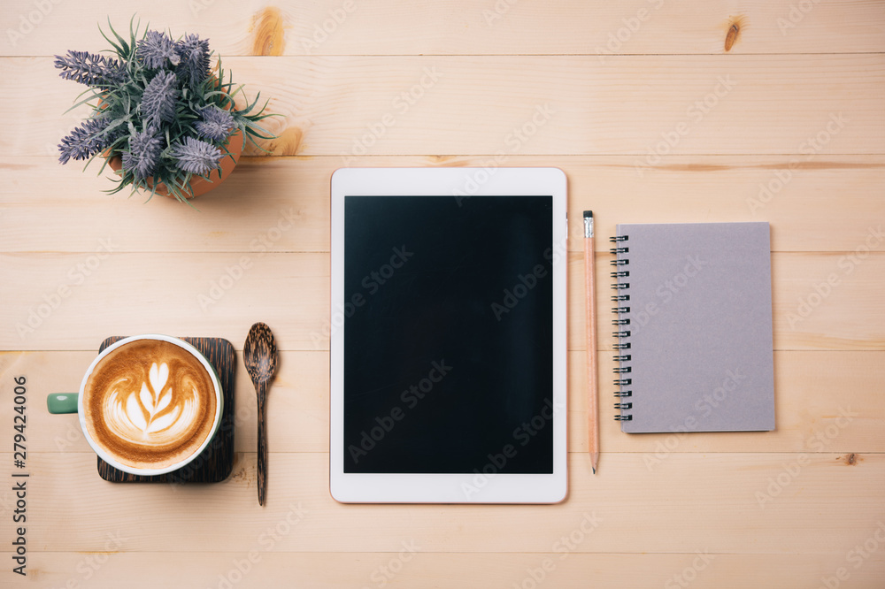Aufkleber top view of tablet empty screen and notebook pencil coffee latte art.copy space for text or design