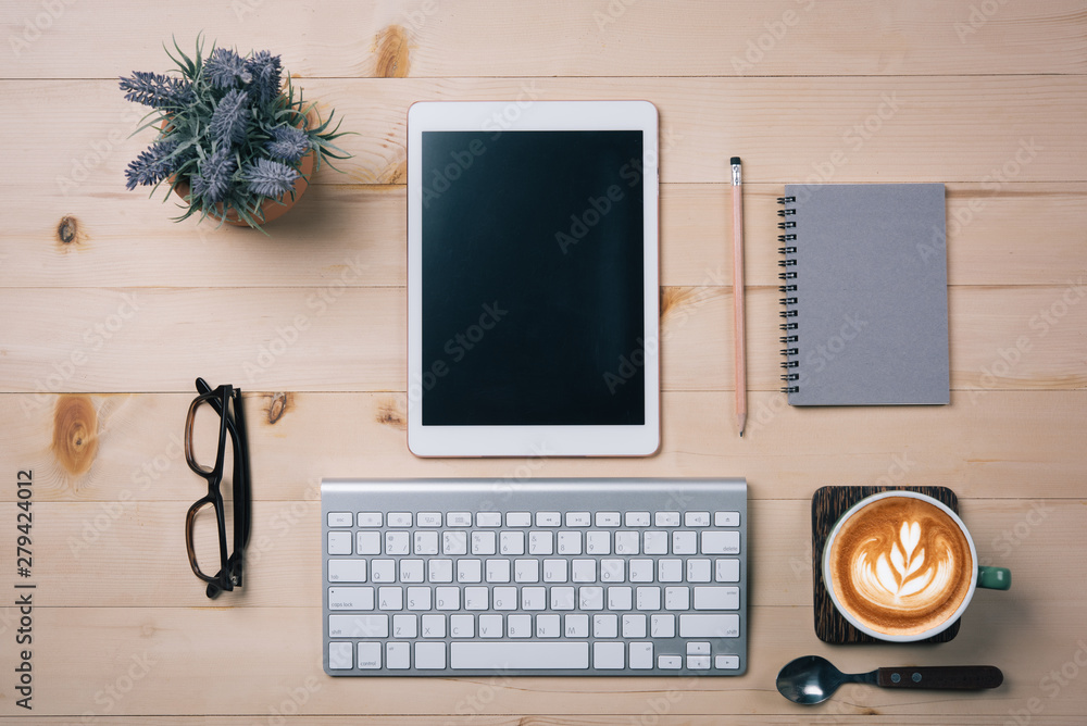Aufkleber top view of tablet empty screen and notebook pencil coffee latte art.copy space for text or design