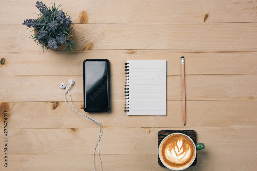 Aufkleber Notebook Blank, notebook with pencil  and smart phone on wooden background.,cup of coffee latte.