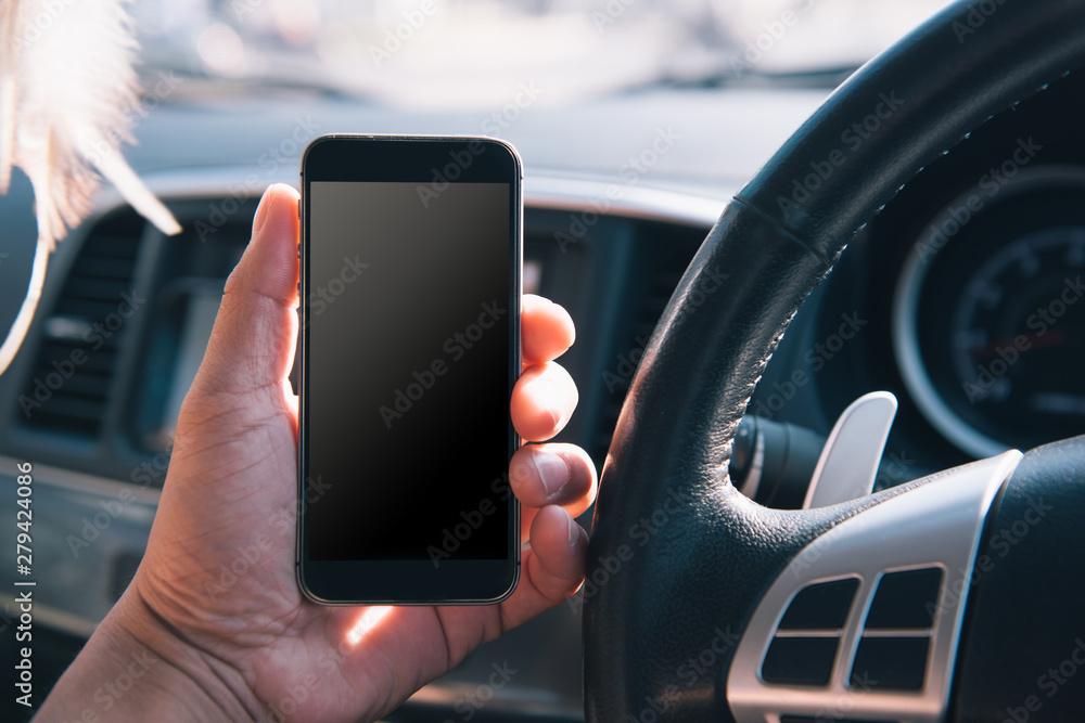 Aufkleber hand using blank white screen mobile smartphone inside a car in sunny day, copy space for your app o