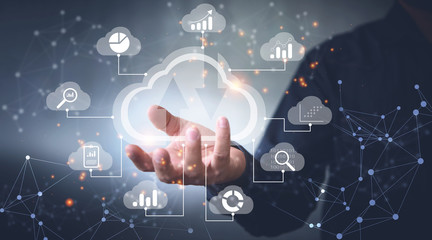 Big data analytics and business intelligence concept with chart and graph icons on a digital screen interface and a businessman in background