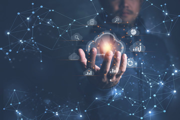 Big data analytics and business intelligence concept with chart and graph icons on a digital screen interface and a businessman in background