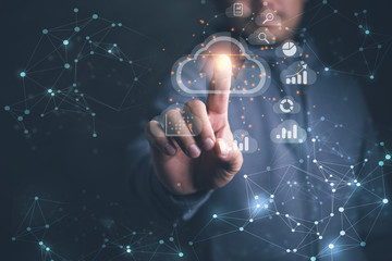 Big data analytics and business intelligence concept with chart and graph icons on a digital screen interface and a businessman in background