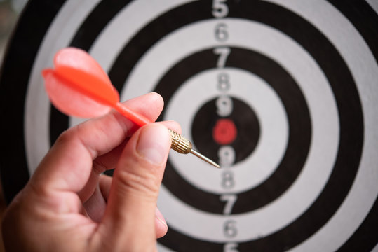 Targeting concept.Bullseye is a target of business. Dart is an opportunity and Dartboard is the target and goal. So both of that represent a challenge in business marketing as concept.