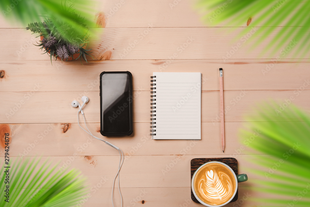 Poster Notebook Blank, notebook with pencil  and smart phone on wooden background.,cup of coffee latte.summer background concept.