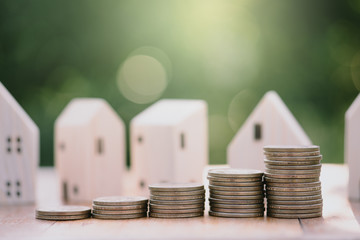 House model and stacking 1 US dollar coin.Business finance and Home loan concept.
