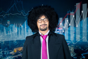 Arrogant smiling businessman with growth graphs