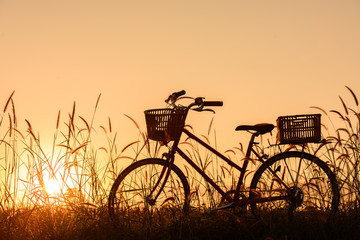 Fototapeta na wymiar beautiful landscape image with Silhouette vintage Bicycle at sunset.classic bicycle, for greeting Cards ,post card