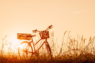 beautiful landscape image with vintage Bicycle at sunset