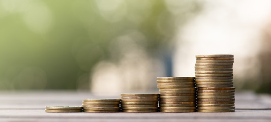 Money coin stack growing graph with sun light bokeh background,investment concept.Business Finance...