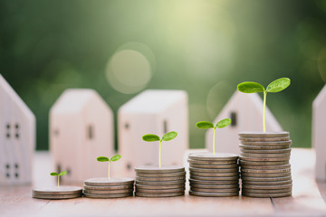 House model and stacking 1 US dollar coin.Business finance and Home loan concept.