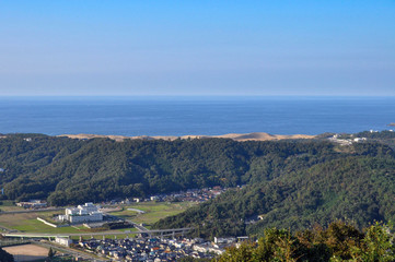 Fototapeta na wymiar View for Tottori city from Tottori castle in Japan. cityscape, sandy beach and sea.