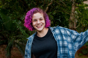 Fototapeta premium Young woman with colorful hair outdoors
