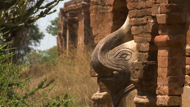 An extreme close up of the sideview of the statue elephant built under an arch in a building