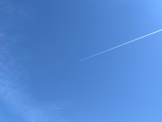 background blue sky and aircraft jet trail with space to write