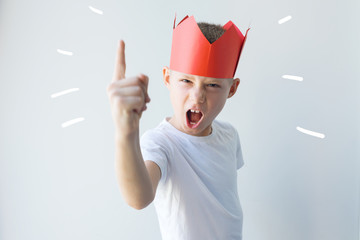 child dictator red paper crown establishes rules - obrazy, fototapety, plakaty
