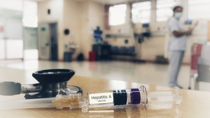Syringe of Hepatitis A vaccine for injection and blurred background of nurse at hospital. This vaccine used for protection and immunization from hepatitis A virus (HAV) infection. Medical vaccine