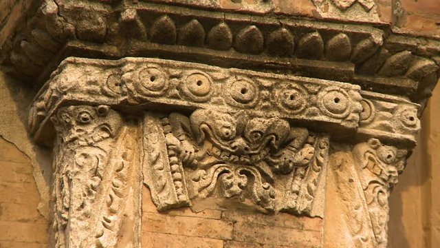 An extreme close up shot of an artistic relief on the pillar of an ancient building in Burma