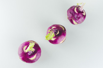 Fresh kohlrabi on white background. Group of raw organic purple turnip cabbage ready to eat.