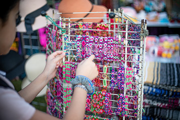 Girl looking at bracelets on rack