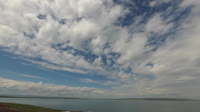 Time lapse clouds, rolling puffy cloud are moving, white lightnes clouds time lapse. Cloud running across the blue sky.Timelapse of white clouds with blue sky in background.