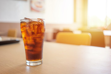 Glass of soft drinks placed on the table gives a refreshing feeling when drinking with mixed sugar and caffeine. with copy spaces.