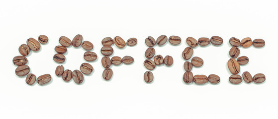 Inscription coffee made of grains on white background