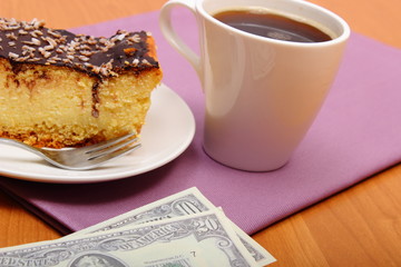 Paying for cheesecake and coffee in the cafe. Finance concept