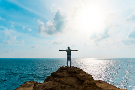 Man rise hands up to sky freedom concept with blue sky and summer beach background.