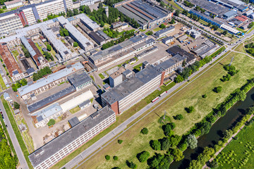 aerial view from drone of urban industrial area with warehouses, buildings, trucks, industry equipment, from above