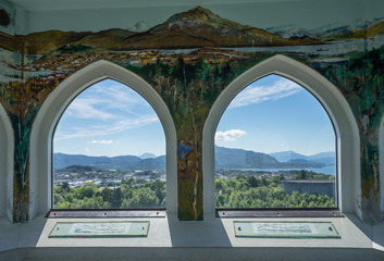 Kristiansund / Norway - June 15 2019: Interior of the Varden viewpoint, the highest point on Kirkelandet. Decorated wall inside, 360 degrees view via arched windows on surrounding mountains and fjord.