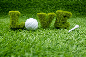 To golfer with love with golf ball on green grass