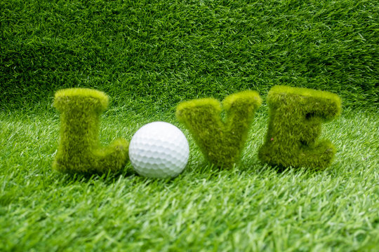 To golfer with love with golf ball on green grass